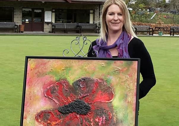Jill Wright with her painting "Sleep in Peace" in memory of her uncle Peter. (s)