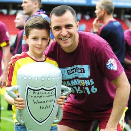 Dean Marney poses for a photo with the trophy