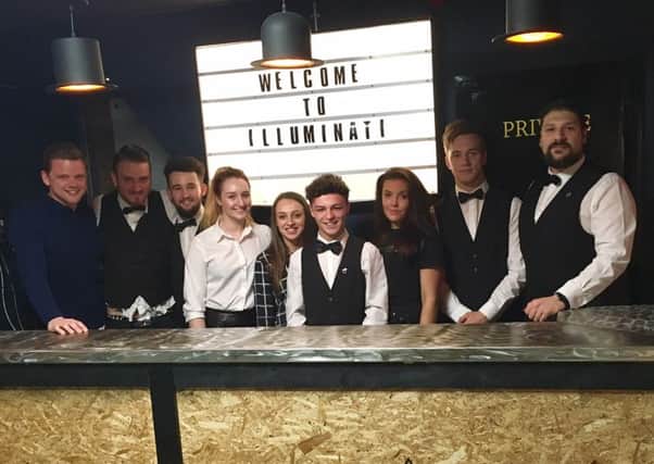 Tom Lord with staff at Illuminati in Burnley. (S)