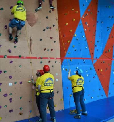 Nine students aged 16 to 19 at Pendle Community College took part in a sponsored wall climb to raise money for Pendleside Hospice. (S)