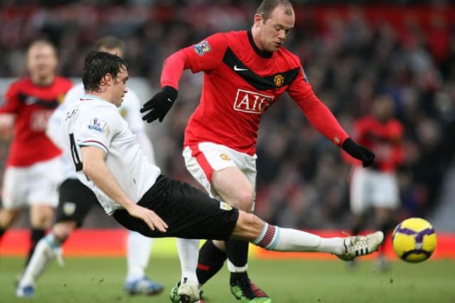 Michael Duff challenges Man Utd's Wayne Rooney