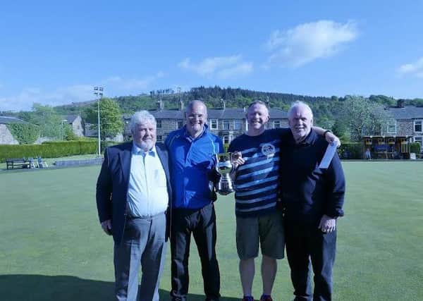 Winners of the Peter Wright memorial doubles competition in Sabden are rpesented with their trophy by Peter's brothers John (left ) and Bob (right). (s)

.