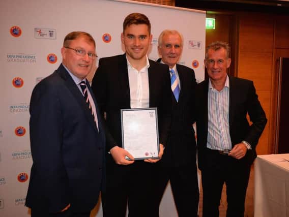 Michael Jolley is presented with his UEFA Pro Licence certificate