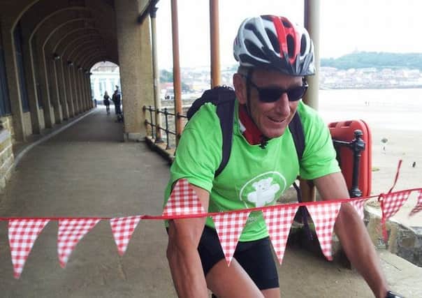 Peter Cockell completes his coast to coast charity cycle ride in Scarborough. (S)