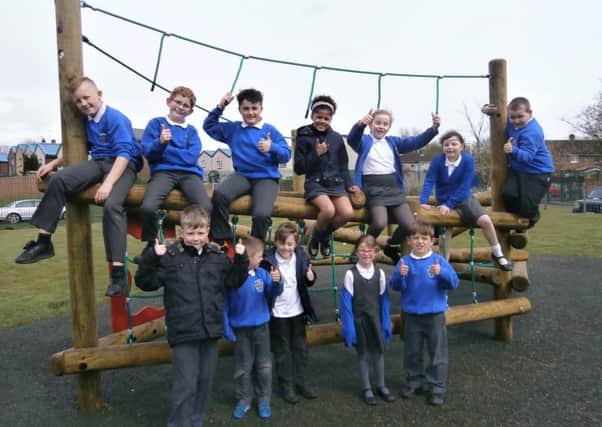 Pupils at Brunshaw Primary School give the new clamber stack the thumbs up. (S)