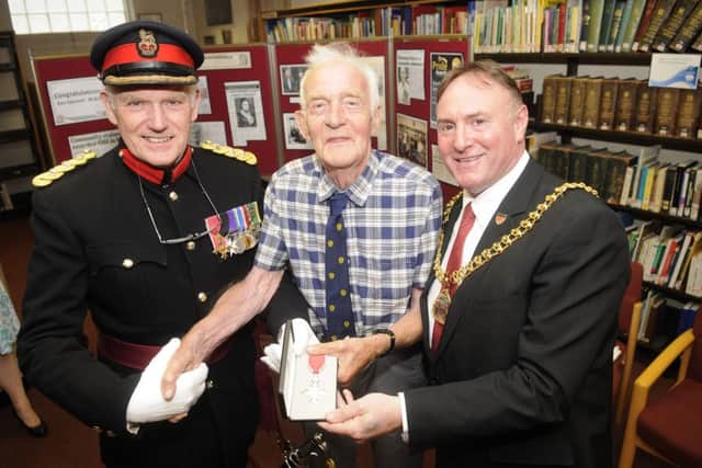 Local historian Ken Spencer is awarded the MBE at Burnley Library.  He is pictured with Vice Lord-Lieutenant of Lancashire Colonel Alan Jolley OBE TD DL and mayor Jeff Sumner.