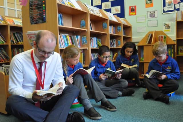 Staff and pupils at Pendle Primary Academy held a readathon in protest at the proposed closure of Brierfield Library. (S)