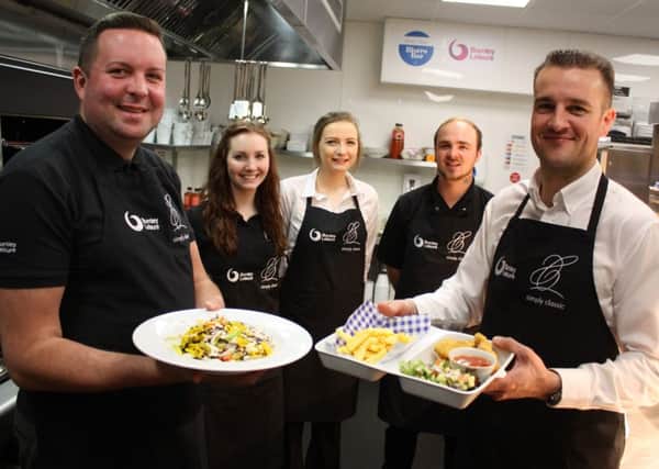 TASTY TEAM: Mark Dempsey from Burnley Leisure (left) and Chris Burt (right) with Simply Classic catering staff (middle)