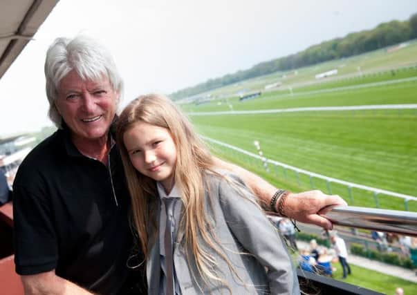 Former Claret Willie Morgan pictured with his granddaughter at Haydock Park