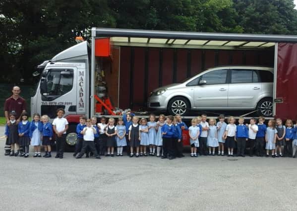 Martin Pennington, of Macadams, with the children and vehicle at Padiham Primary School (s)