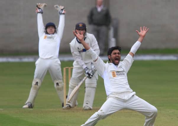 Burnley captain Bharat Tripathi and wicket-keeper Chris Burton appeal in vain for a lbw decision in the game against Lowerhouse.