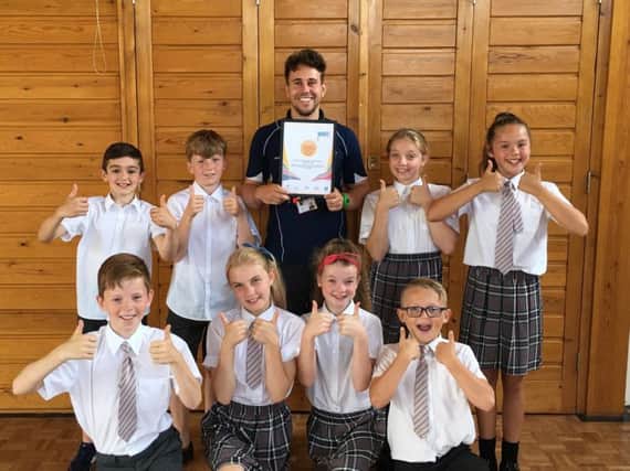 Mr Little and some of the students at Christ the King Primary School celebrate receiving their Sainsbury's School Games gold award