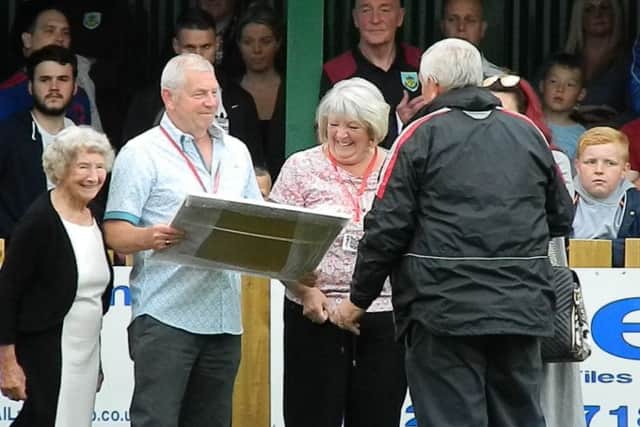 Brian Coates receives a commemorative plaque from Dave Blacklock