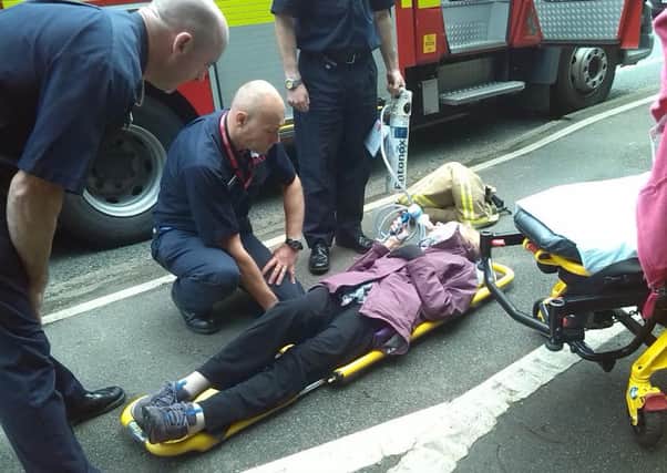 82-year-old Joan Carpenter from Chorley, is treated by medics for a broken hip outside Chorley A&E where she was protesting the department's closure but she was taken 15 miles to an A&E in Preston.