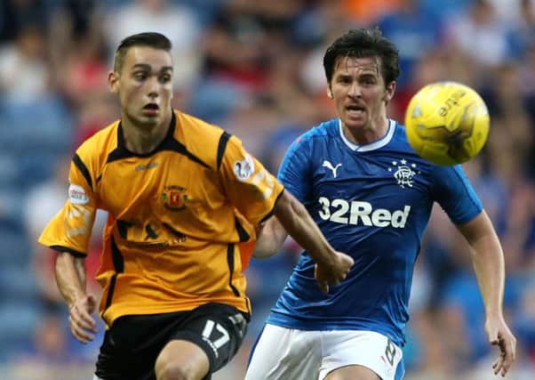 Rangers' Joey Barton (right) challenges Annan Athletic's Przemyslaw Dachnowicz during the Betfred Cup, Group F match at the Ibrox Stadium, Glasgow. PRESS ASSOCIATION Photo. Picture date: Tuesday July 19, 2016. See PA story SOCCER Rangers. Photo credit should read: Andrew Milligan/PA Wire. EDITORIAL USE ONLY