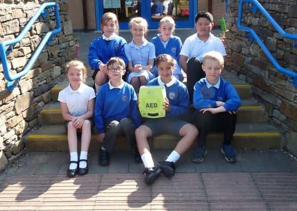Padiham Primary School pupils with the defibrillator that was donated to the school by  an anonymous well wisher (s)