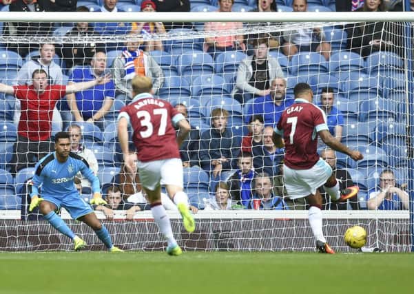 Andre Gray opens the scoring from the spot at Ibrox