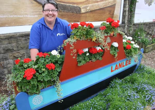 Canal and River Trust project officer Emma Fielding with a blooming boat