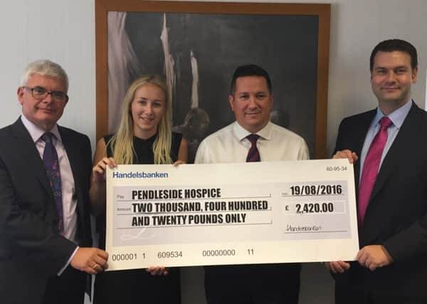 Staff from Handelsbanken Burnley with a cheque for Pendleside Hospice