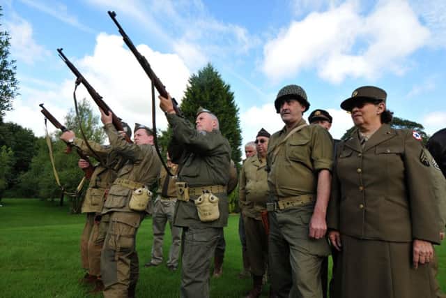 Photo Neil CrossWW2 re-enactors in full uniform firing gun salute at funeral of Neil Killin at Burnley Crematorium