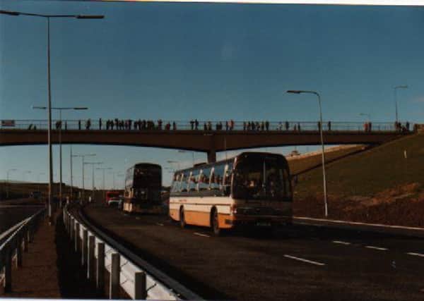 Traffic waiting for the official opening of the first completed section of the M65 in October, 1981. Spectators line the bridge, above. (s)