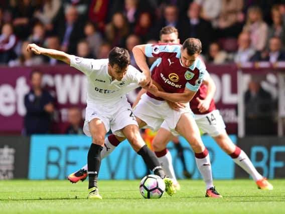 Dean Marney tangles with Jack Cork