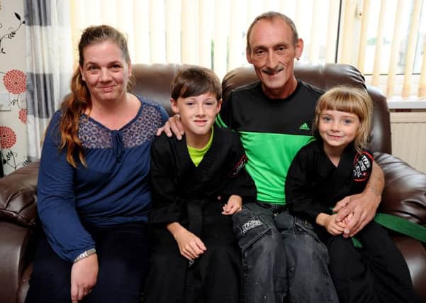 Ray Holloway aged 10 from Burnley is suffering from Leukaemia and has just been awarded an honorary black belt by the martial arts group at St Peters Centre. Seen here with dad Ray senior, mum Sandra and sister Chelsea aged 6. Picture by Paul Heyes, Sunday August 14, 2016.