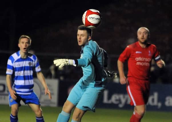 Action from the Lancashire FA Challenge Trophy semi-final between Lancaster City (blue and white) v Padiham, at the County Ground in Leyland.Padiham keeper Mike Donlon turns a shot away.  PIC BY ROB LOCK23-2-2016