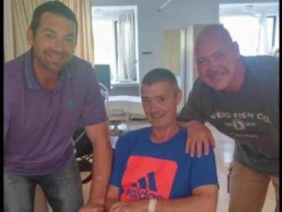 Stroke victim David Kenyon with his friends Paul Keenan (left and Richard Reeves, who completed a sponsored walk from Burnley to Windermere to raise 2.500 towards his rehabilitation.