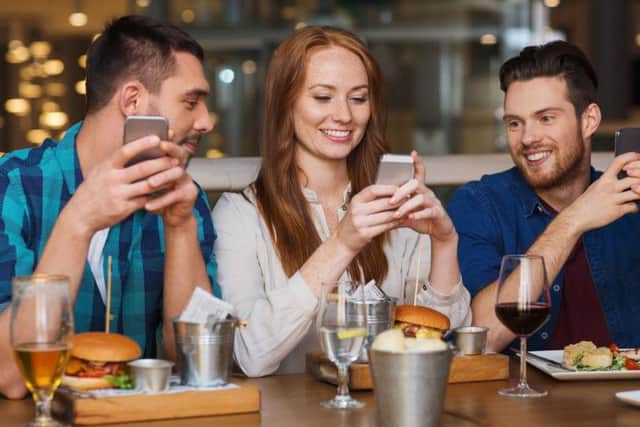 More and more people are using their phones while eating out