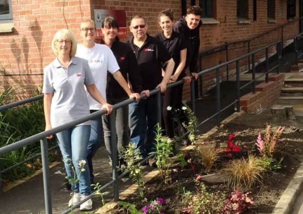 Volunteer gardeners Cheryl Fitton, Jenny Swindells, Laura Walsh, Nick Pollard, Frankie Thompson and Oli Robinson with some of the flowers they planted at the hospice. (s)
