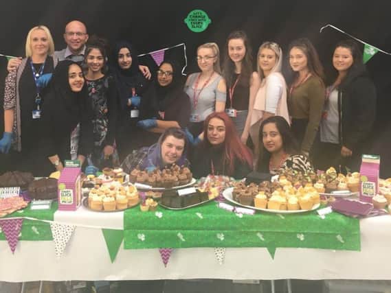 Students and staff at Burnley College unveil their selection of cakes at the Macmillan coffee morning event.