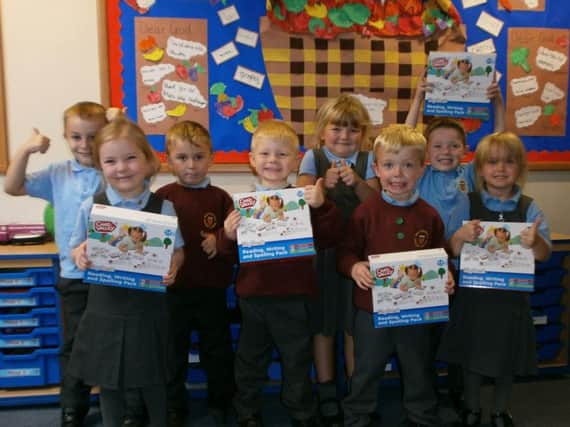 Reception class pupils at Holy Trinity Primary School in Burnley show their delight and appreciation of the gifts received from the Burnley Retail Park Argos store.