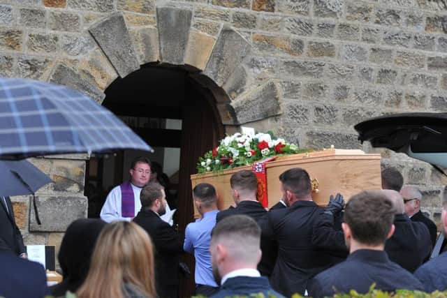 Dean's coffin is carried into the church