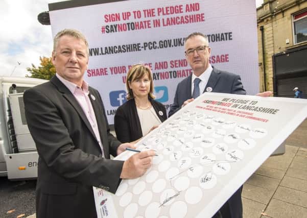 Burnley Council leader Mark Townsend signs the pledge with Burnley Council chief executive Pam Smith and the Police and Crime Commissioner for Lancashire Clive Grunshaw (s)