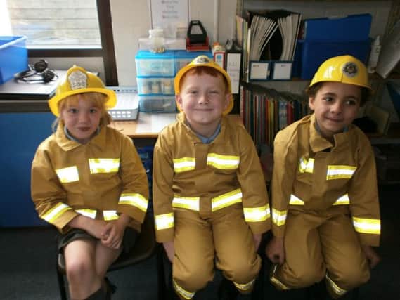 Mini firefighters for the day at Holy Trinity Primary School, Burnley are year two pupils Skye Heald, Brogan-Joe Hargreaves and Sam Grant. (s)