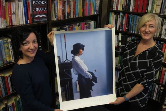 Town Centre Manager Catherine Price and Burnley Brand Manager, Amber Corns with the art prize a signed print donated by Jack Vettriano