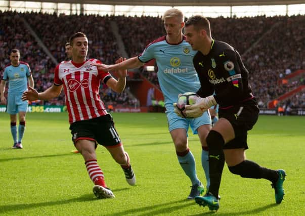 Ben Mee shields the ball from Dusan Tadic