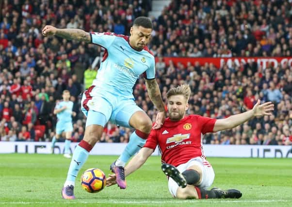 Andre Gray vies for possession with Manchester United's Luke Shaw
