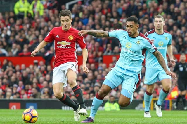 Andre Gray runs at the Manchester United defence