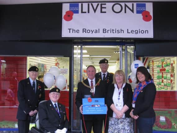 The Burnley poppy shop is officially opened by the Mayor of Burnley Coun. Jeff Sumner and members of the Burnley branch of the Royal British Legion, with (left to right) Dav id Elliott, Mike Ellliott, chairman,  Ken Nield and his wife Barbara and their daughter Jenny. (s)