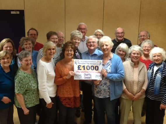 Members of the Fifty-Something Theatre Company with a cheque for Pendleside Hospice. (s)