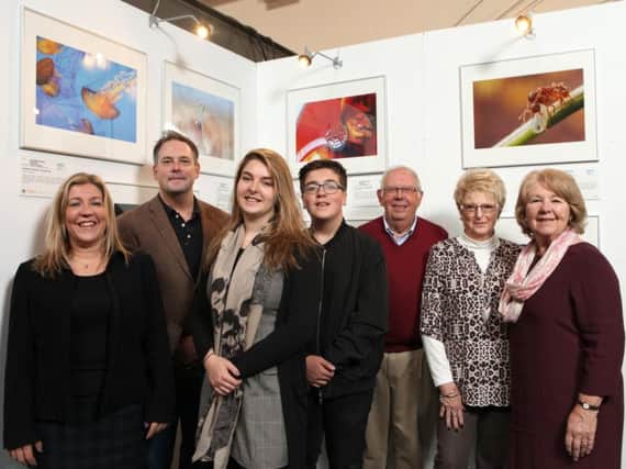 Jessica, surrounded by her family, next to her winning entry at the exhibition at the Royal Exchange Theatre in Manchester.