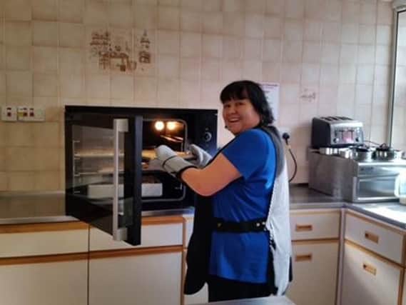 Volunteer cook Dawn Copeland with the donated oven.