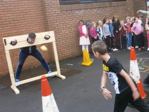 Sports co-ordinator Mr Simon Grime takes a good old soaking in the stocks as part of the Children in Need fund raising at Holy Trinity Primary School in Burnley. (s)