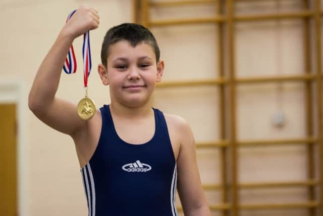 David Siko with the medal he won whilst wrestling