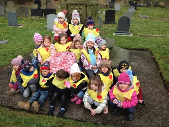 Children from Briercliffe Day Nursery pictured with their hand-made poppy tribute for Remembrance Sunday.