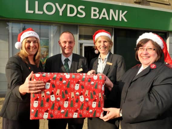 Captain Maisie Veacock with Jane Harrison, customer assistant, Richard Buckley, manager of the Burnley branch of Lloyds Bank and Jennifer Thomas, assistant manager.