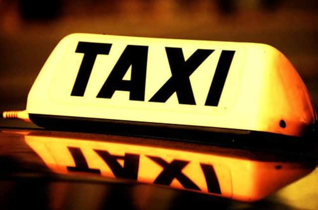 close up on a yellow taxi cab sign