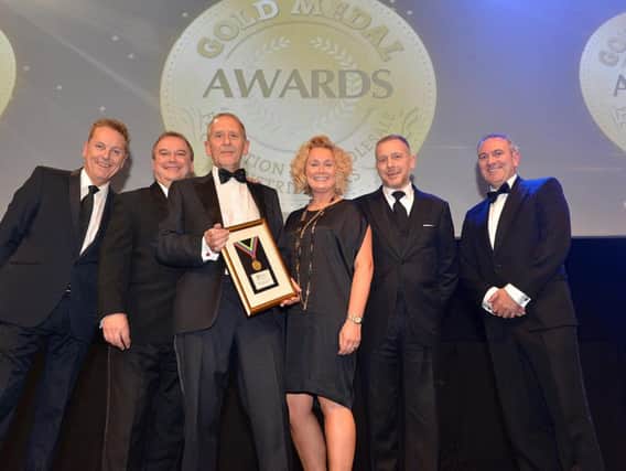 Justin Birchall (second right) with his wife, sales director Louise; company chairman Colin Birchall (third left) and Master of Ceremonies Brian Conley; (forward) chairman Martin Williams and Damian McLoughlin, sales director UK & Ireland at Unilever Food Solutions.
